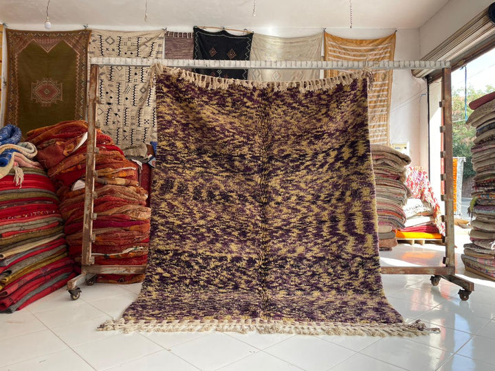Lifestyle shot of a vintage Azilal Moroccan rug featuring geometric patterns in brown and cream.
