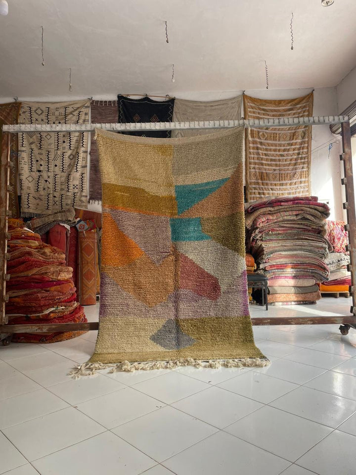 Lifestyle shot of a colorful Moroccan rug with geometric patterns in a natural setting.