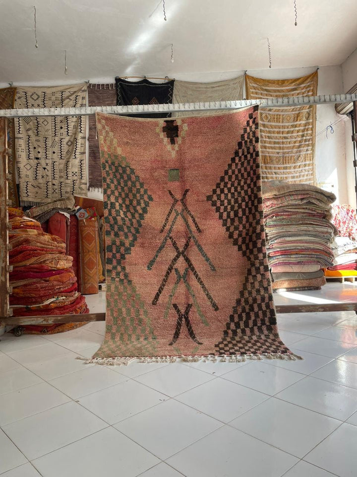 Lifestyle shot of a colorful Boujaad Moroccan rug with tribal patterns in natural setting.