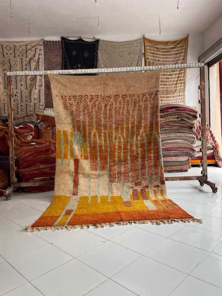 Lifestyle shot of the yellow vintage Boujaad Moroccan rug with fringe edges in a natural setting.