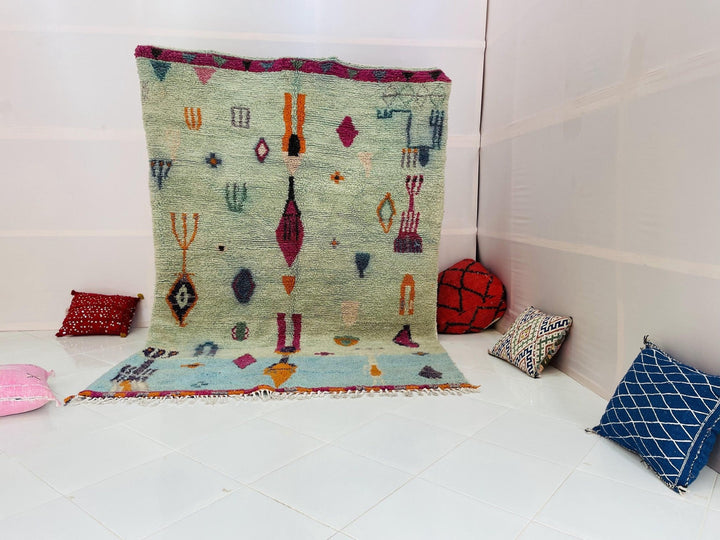 Lifestyle shot of the blue and red abstract Beni Ourain Moroccan rug on a white background.