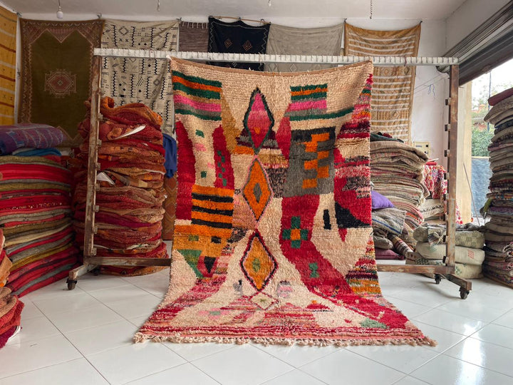 Lifestyle shot of a colorful Berber rug featuring geometric patterns in a studio setting.