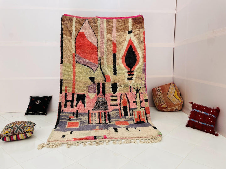 Lifestyle shot of a multicolor Moroccan rug featuring an abstract design with fringe edges.