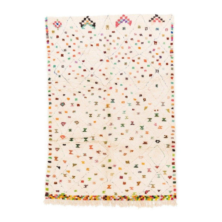 Front view of a cream pastel dotted Moroccan rug with polka dot pattern and fringed edges.
