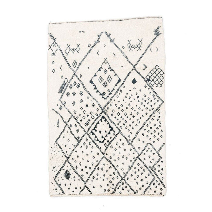 Front view of the ivory geometric tribal area rug featuring a black pattern.