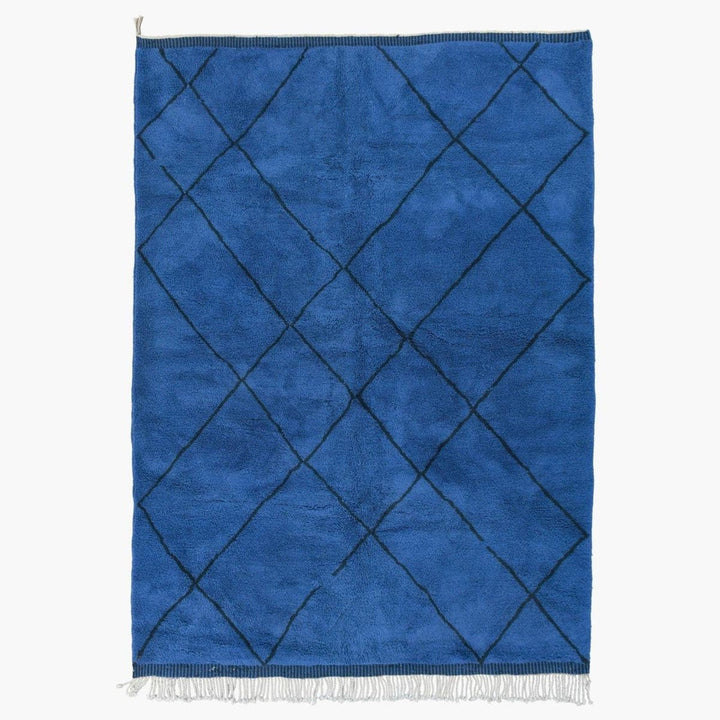 Front view of the blue diamond pattern rug with a white background.