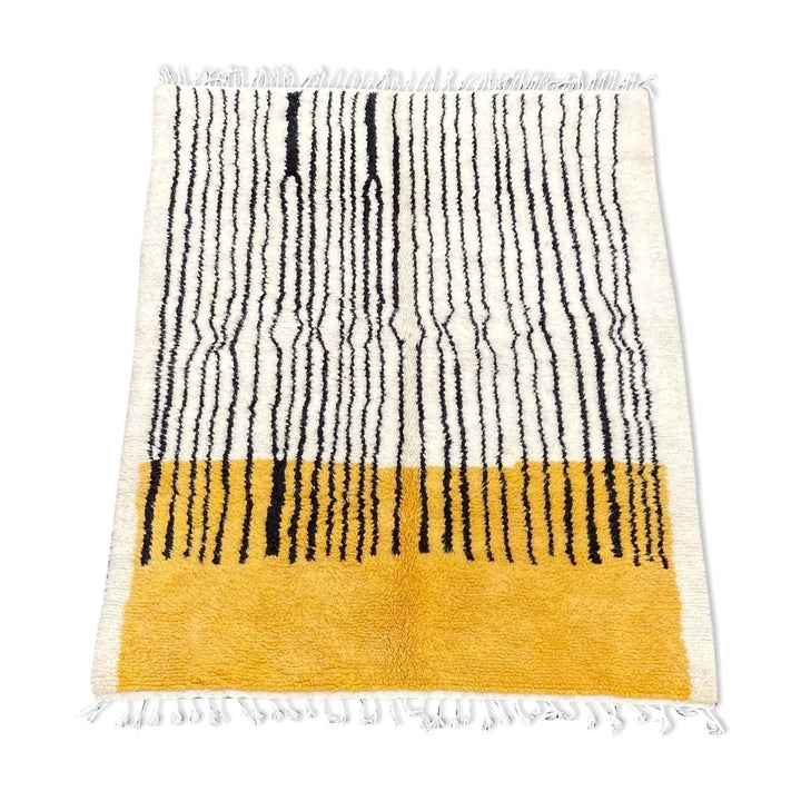 Front view of the yellow and black striped Beni Ourain rug with fringe edges.
