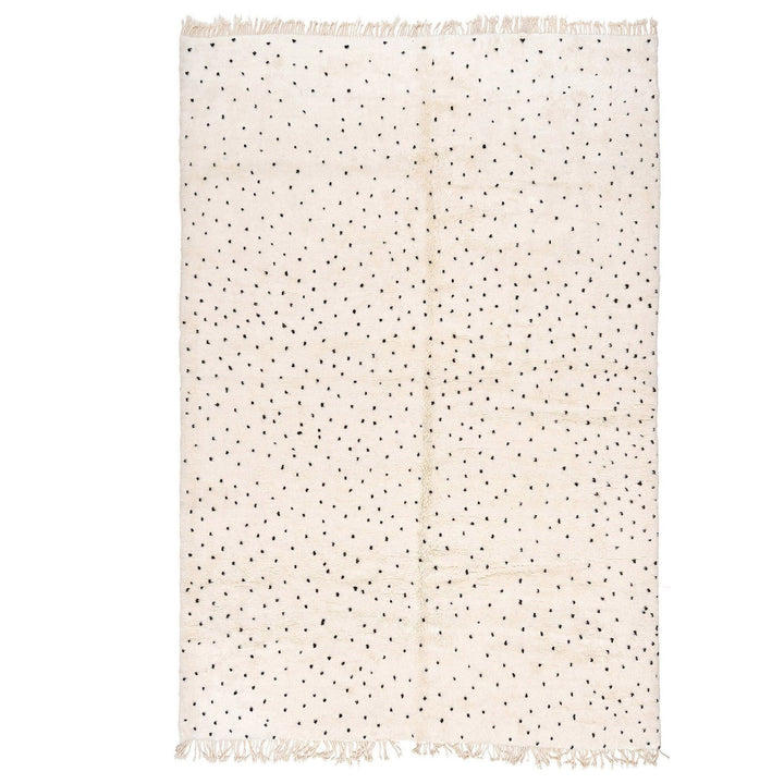 Front view of an off-white polka dot rug with a black pattern on a white background.