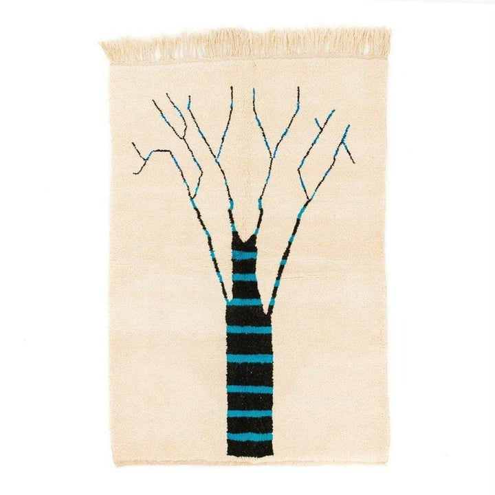 Front view of the cream tree design rug featuring abstract patterns in beige, black, and blue.