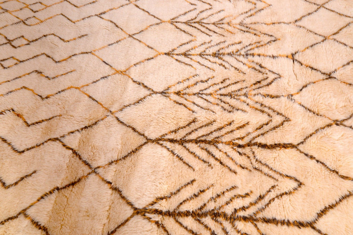 Close-up detail of the beige and brown geometric Moroccan rug showcasing intricate patterns and a textured surface.