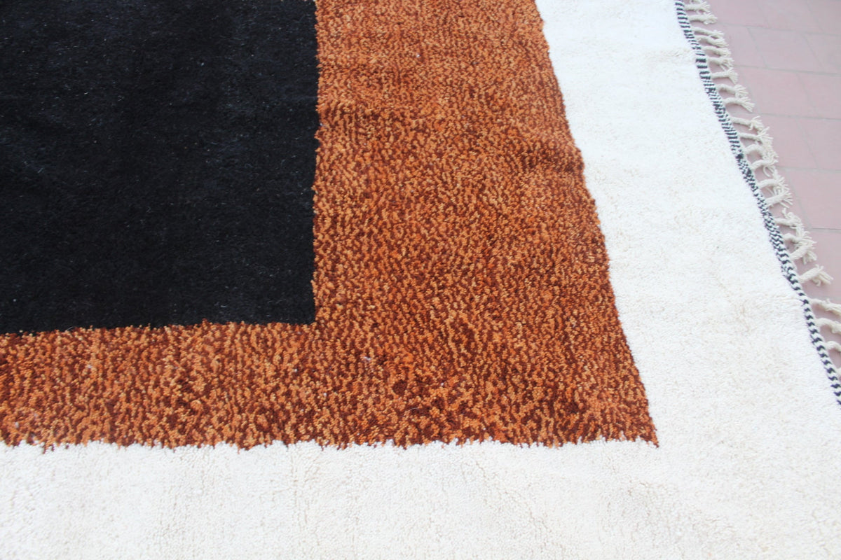 Detail close-up of a Moroccan Beni Ourain rug highlighting its textured surface in natural colors.
