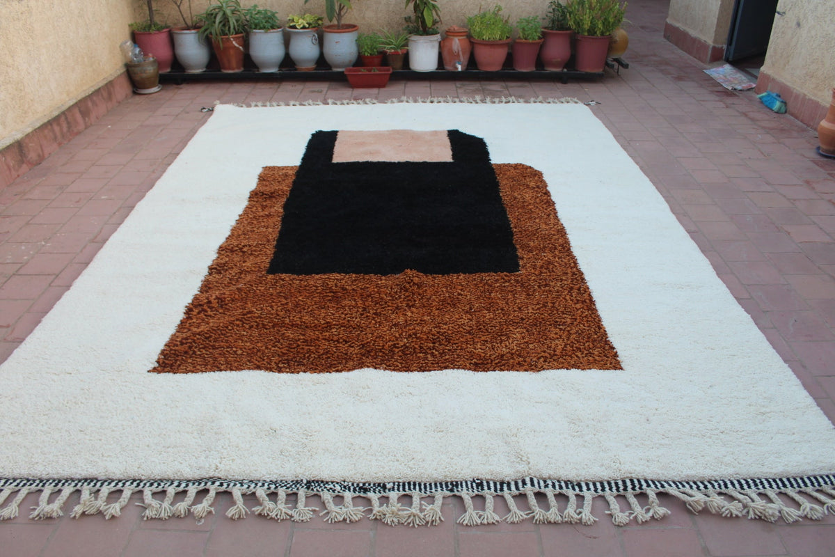 Lifestyle shot of a Moroccan Beni Ourain rug with a geometric design in black, brown, and white.