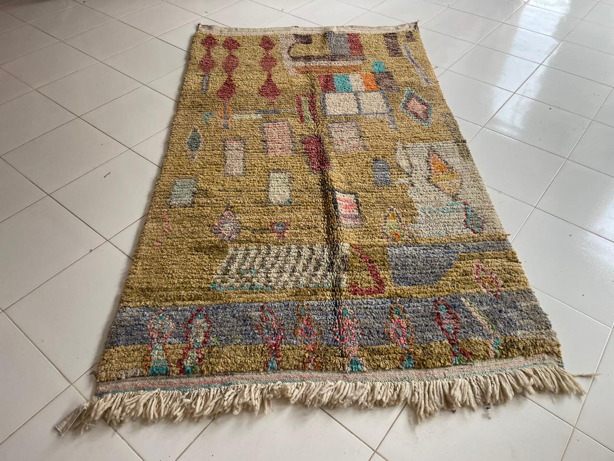 Front view of a vintage Moroccan rug featuring geometric patterns and fringe edges in yellow, blue, and red.
