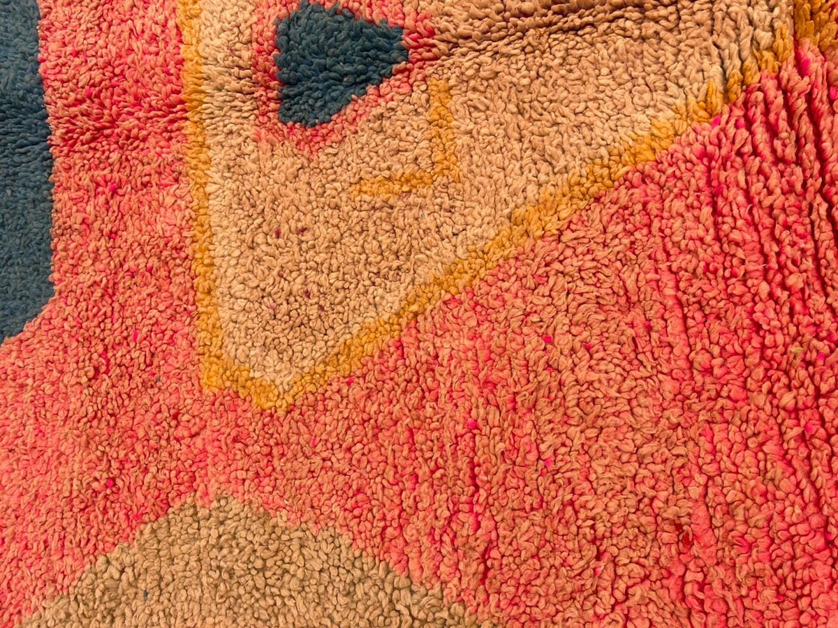 Detail shot showcasing the intricate design and soft texture of the pink Moroccan rug.