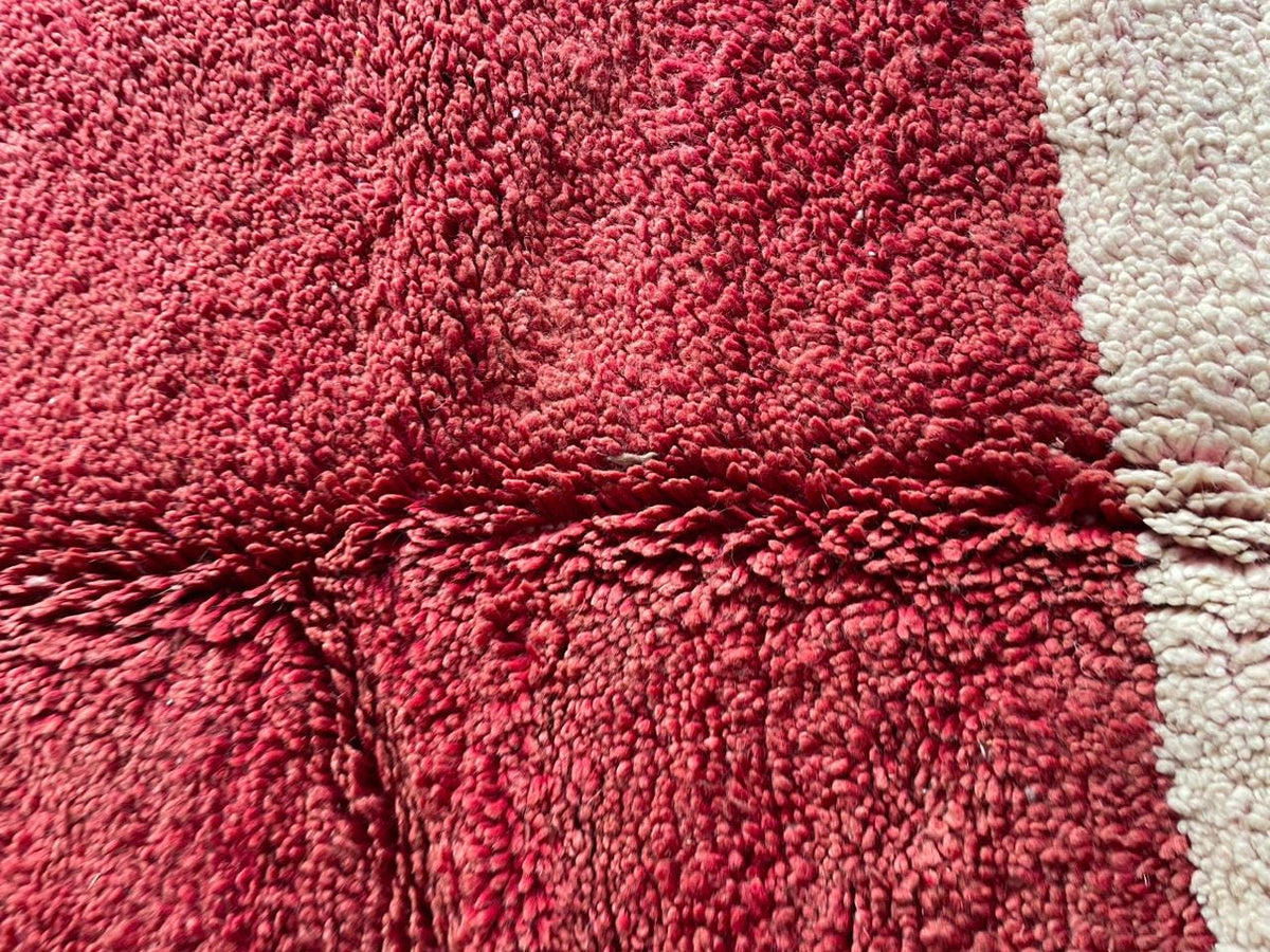 Detail close-up of a Moroccan rug highlighting its textured surface and color contrast in a studio.
