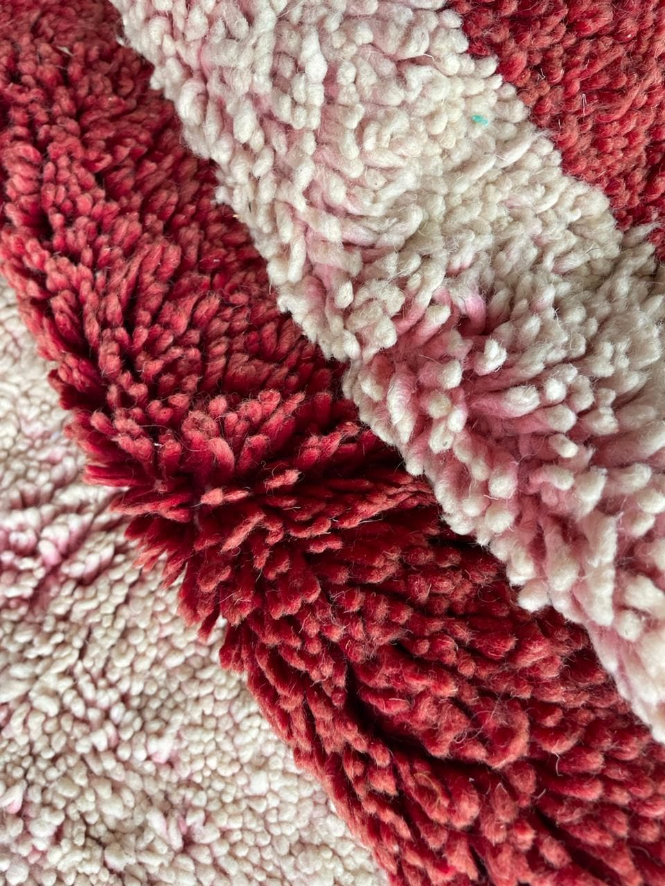 Detail close-up of a vintage Moroccan rug emphasizing its textured surface and geometric pattern.