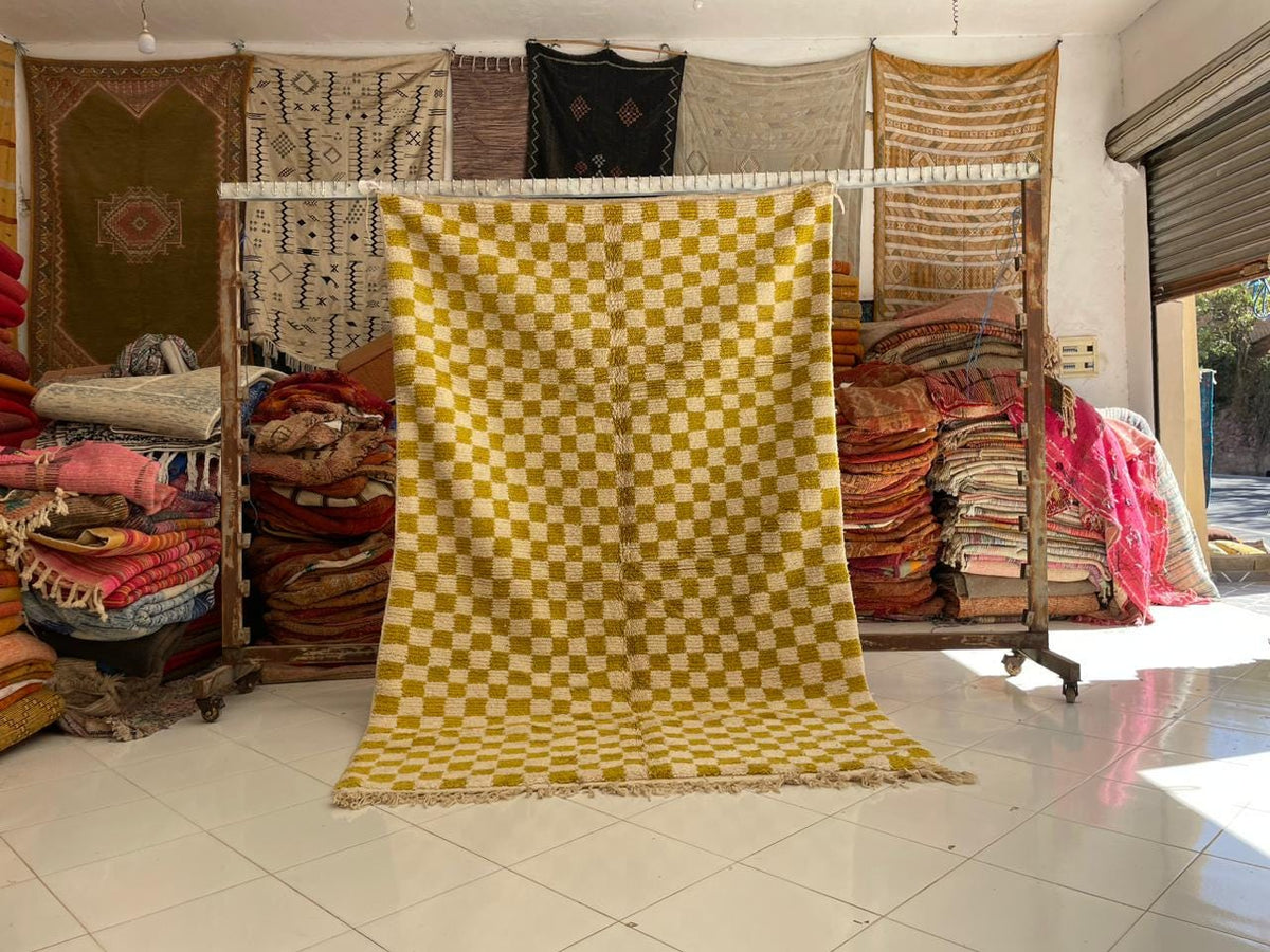 Lifestyle shot of a yellow wool rug displayed in a natural setting.