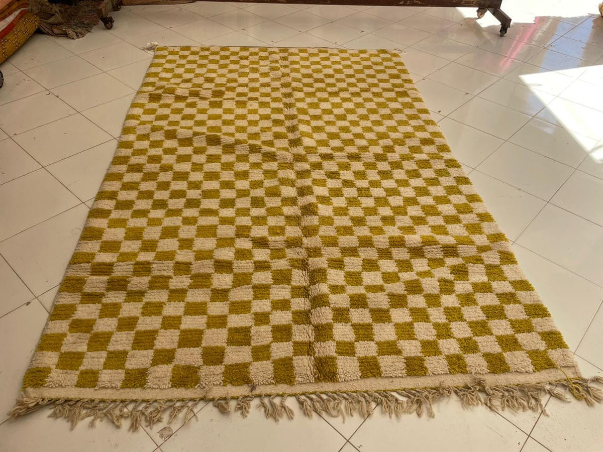 Front view of a yellow Moroccan rug featuring fringed edges and a checkered design.