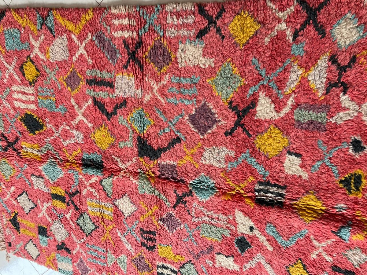 Close-up detail of the pink vintage Moroccan rug highlighting its textured surface and patterns.