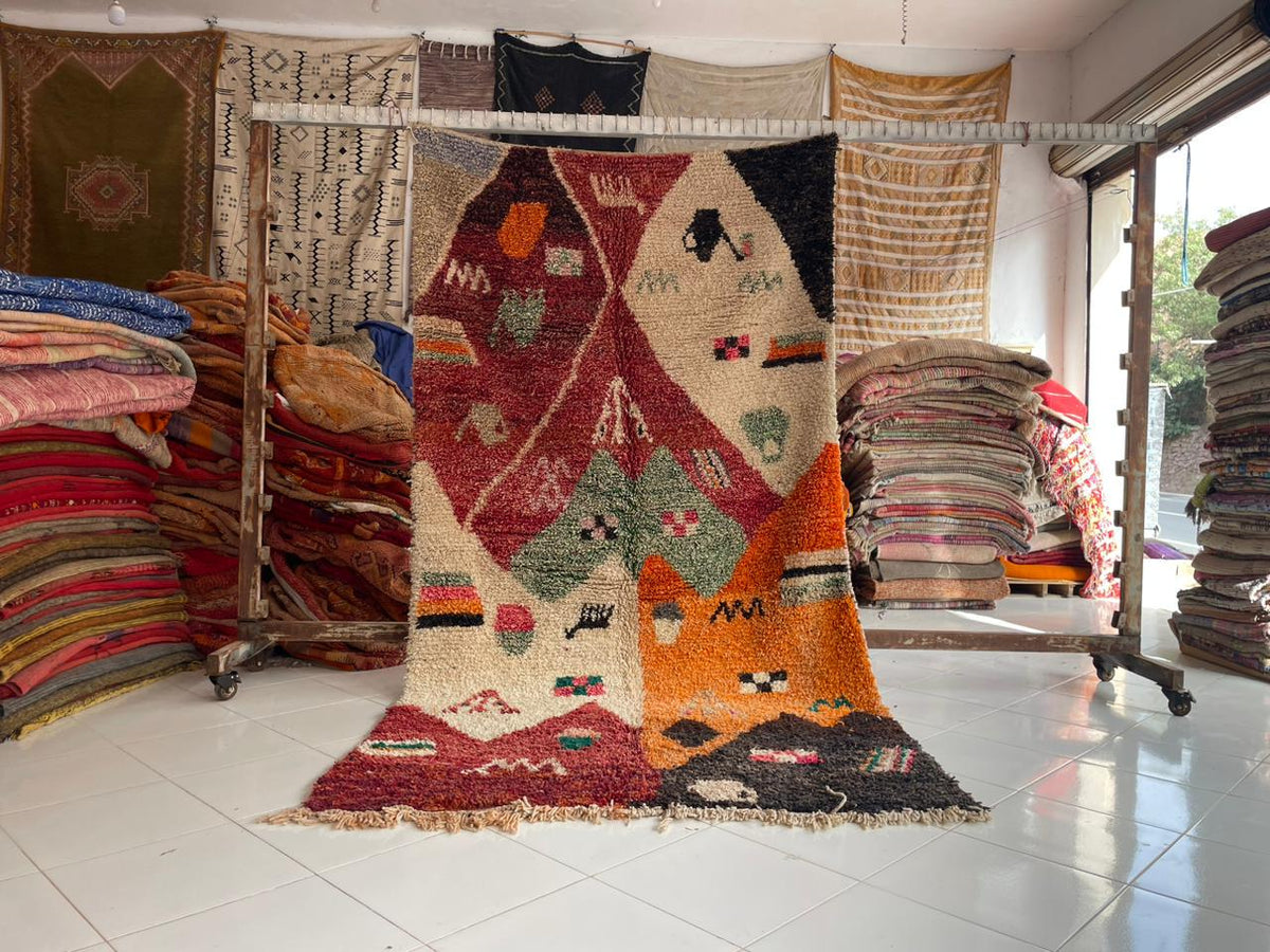 Lifestyle shot of a colorful vintage rug with geometric patterns displayed in a natural setting.