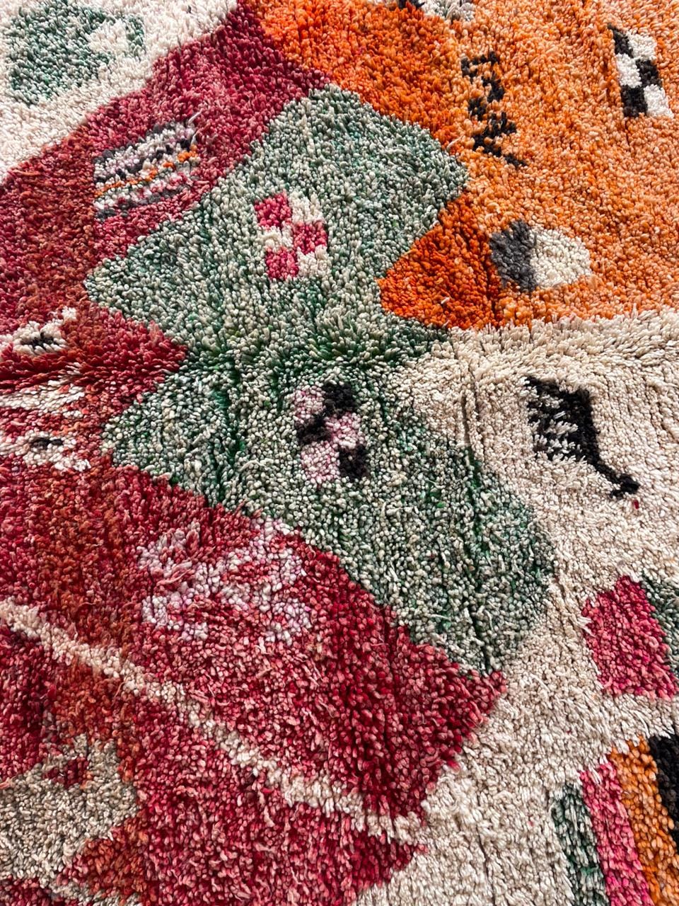 Close-up detail of the vintage Moroccan rug highlighting its textured surface and decorative motifs.