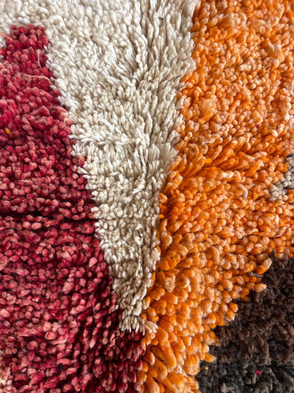 Front view of a vintage Moroccan rug displaying bold colors and distinct shapes.