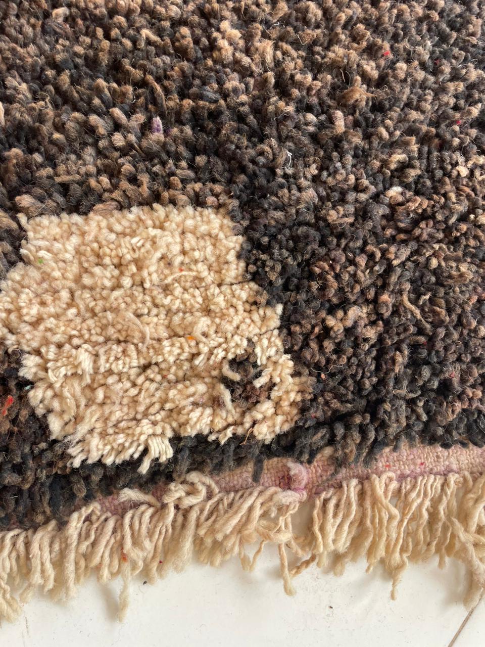 Close-up detail of the woven texture on the vintage rug made from natural fibers.