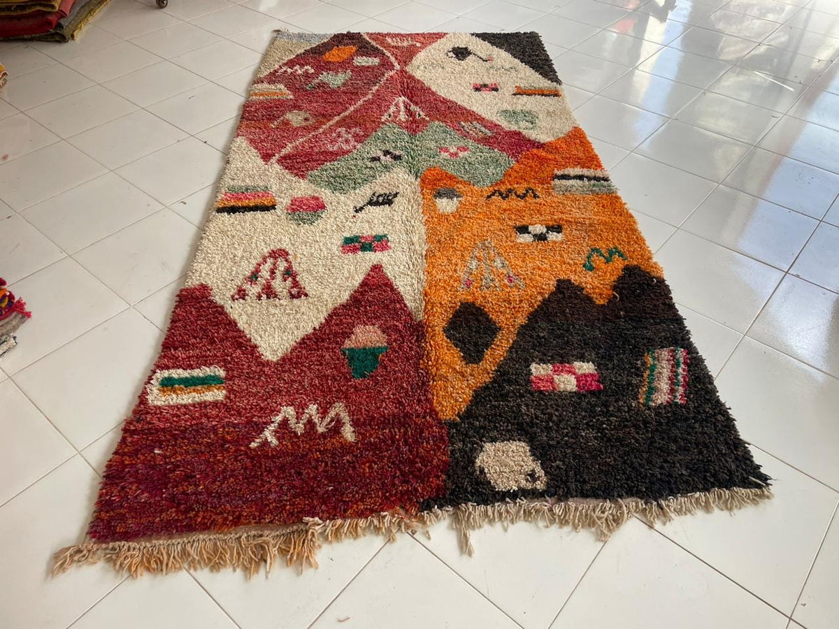 Front view of a vintage Moroccan rug showcasing bold colors and geometric designs.