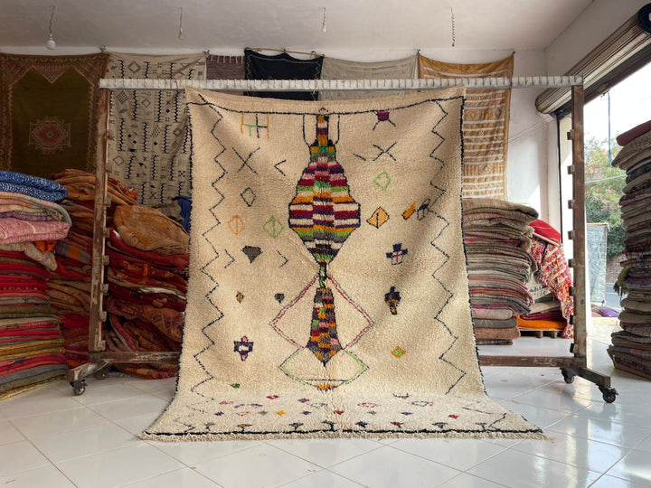 Lifestyle shot of a vintage Moroccan rug with geometric patterns in beige and multicolor.