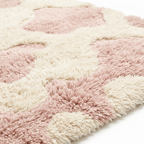 Close-up detail of the textured design on a baby pink Moroccan rug.