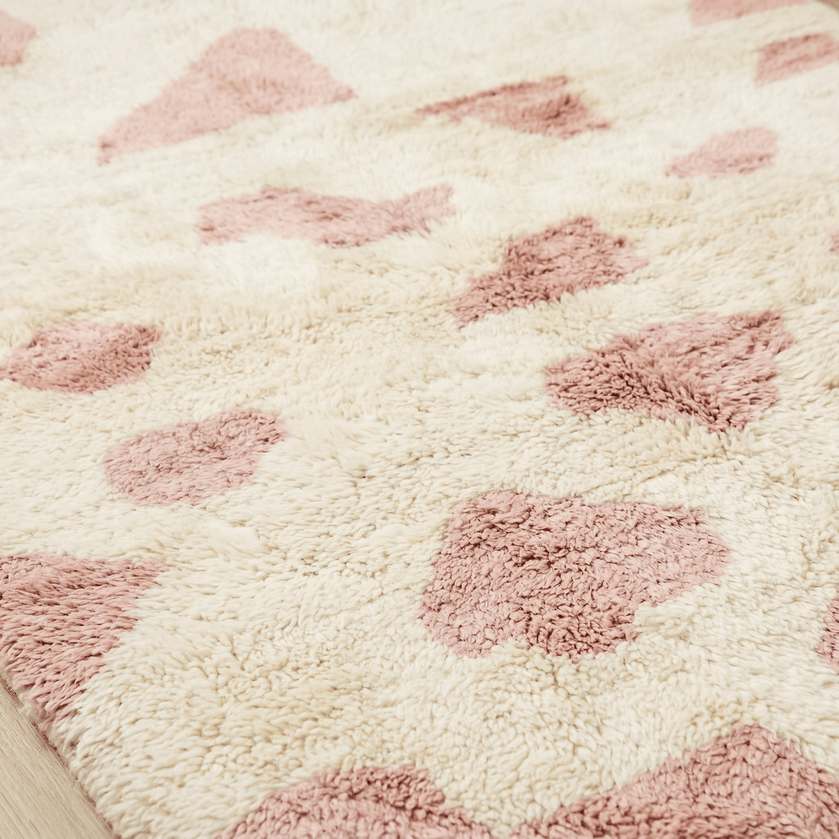 Detail shot highlighting the plush pile and patterned design of the baby pink Moroccan rug.