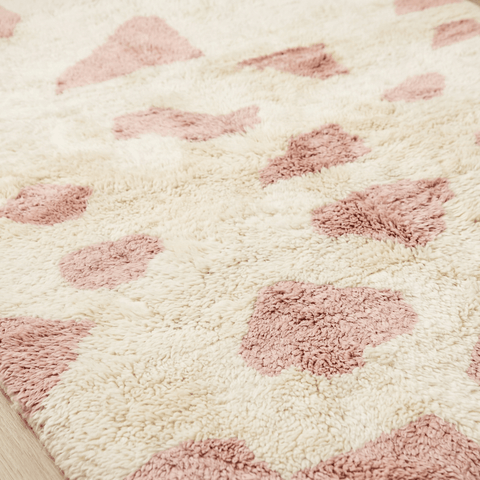 Detail shot highlighting the plush pile and patterned design of the baby pink Moroccan rug.