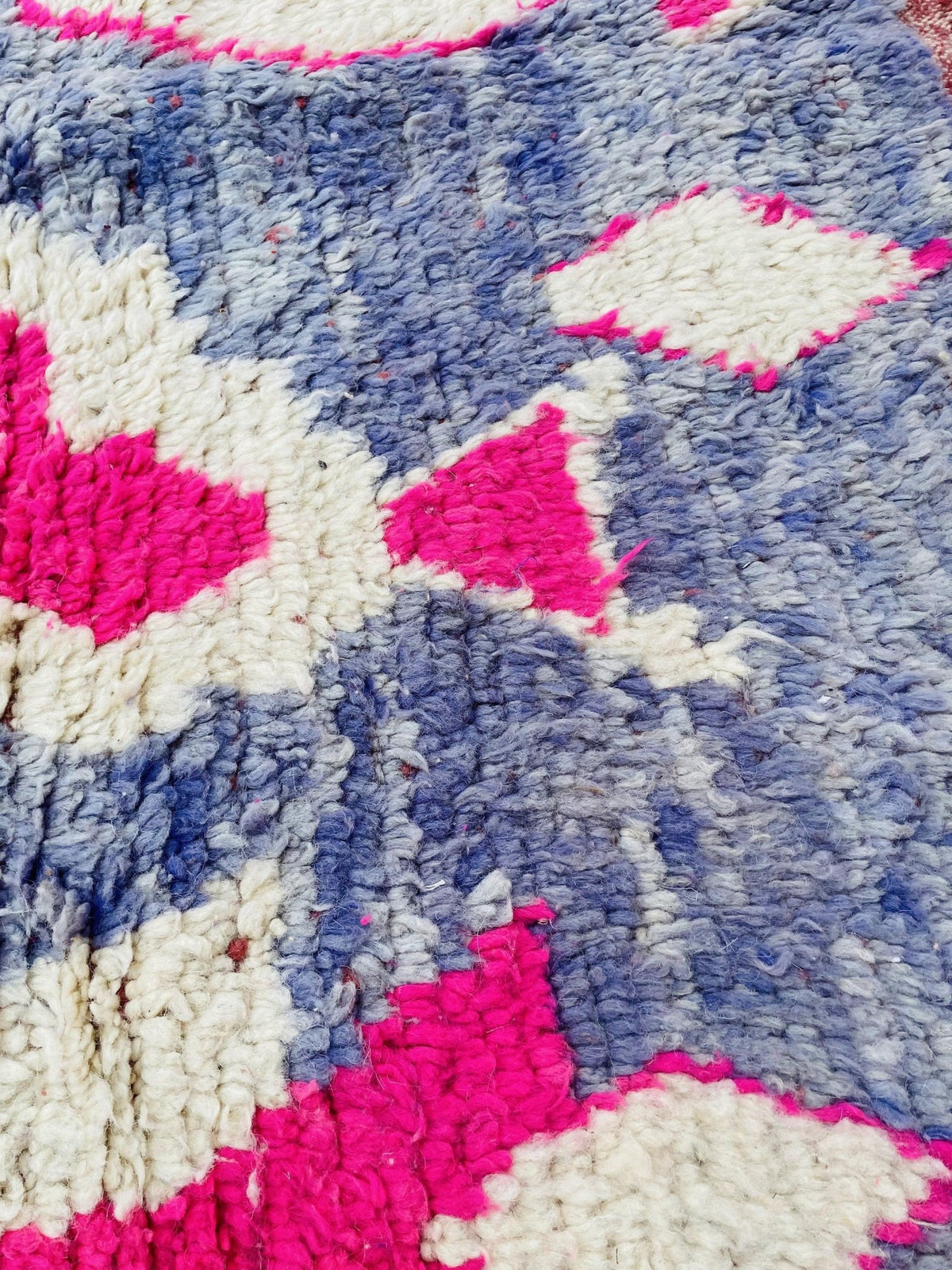 Detail shot of a vintage Boujaad Moroccan rug showcasing an abstract design and woven texture.