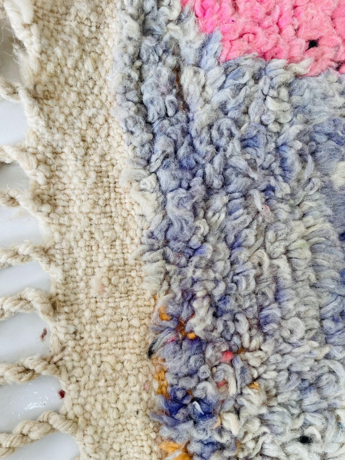 Detail shot highlighting the textured fibers and woven patterns of the vintage Boujaad Moroccan rug.