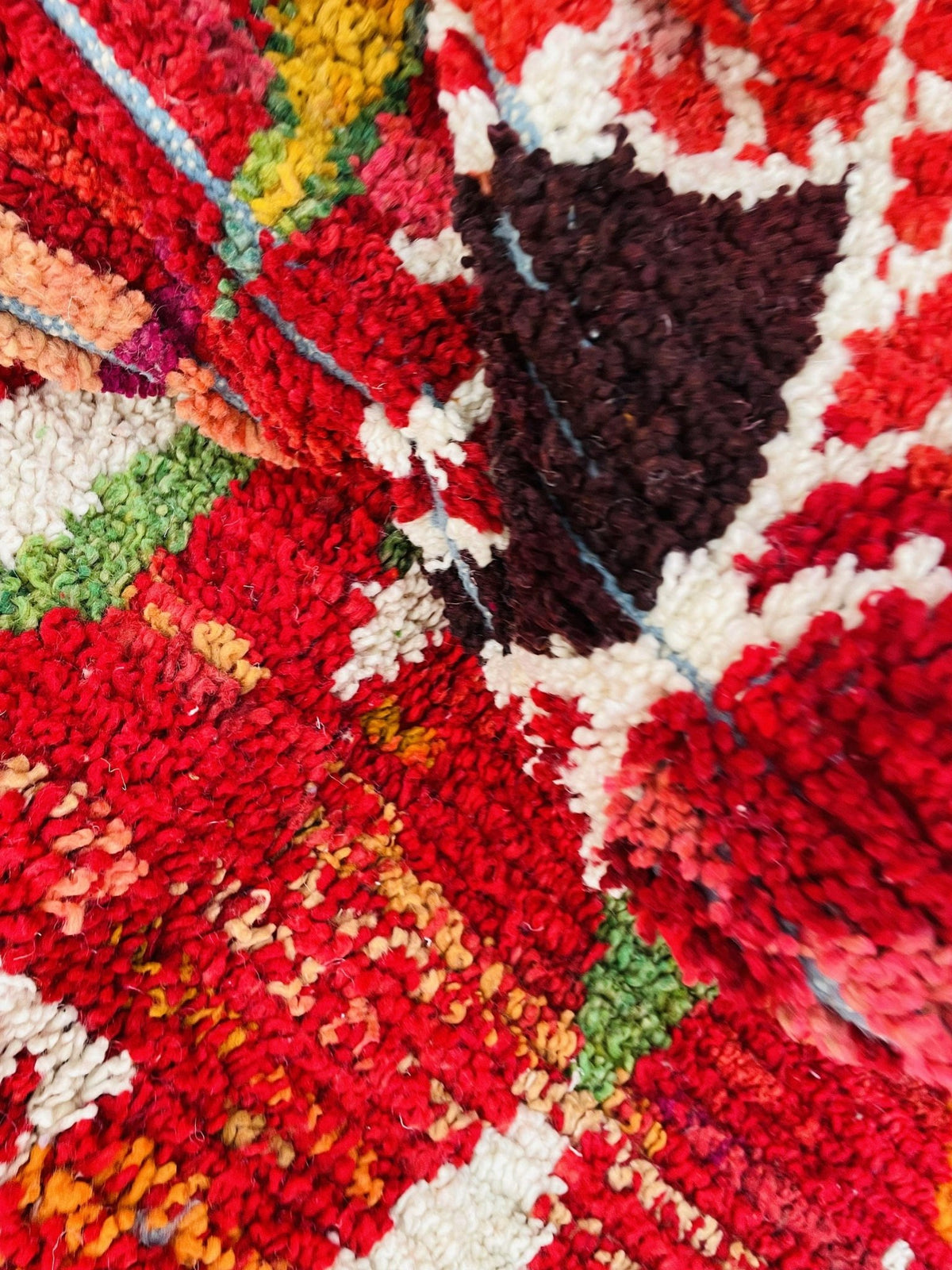 Lifestyle angle showcasing a red vintage Moroccan rug with intricate tribal patterns.