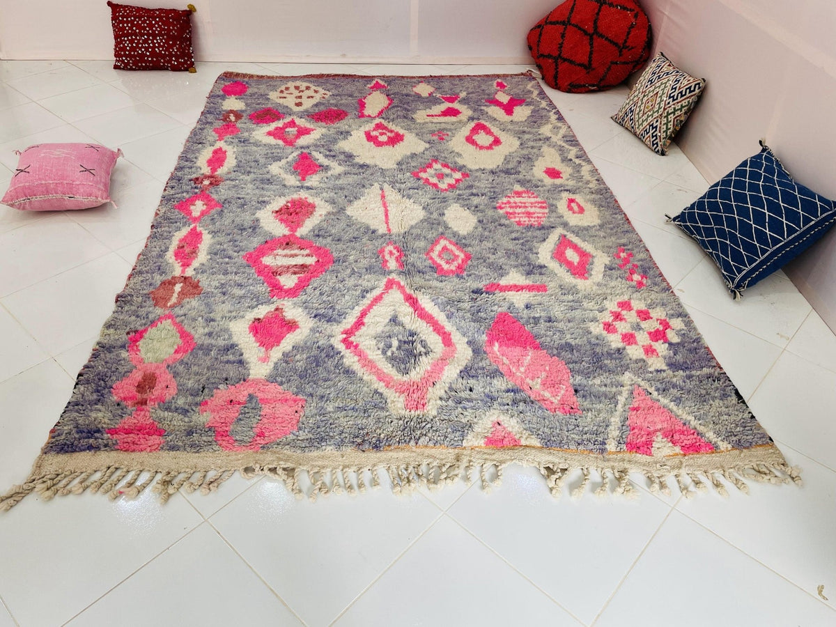 Lifestyle view of a red vintage Boujaad Moroccan rug featuring fringe edges and tribal designs.