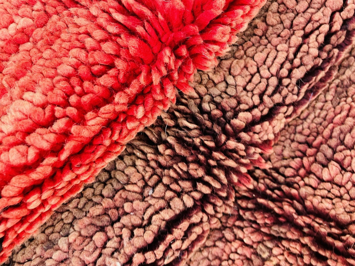 Close-up detail of the textured surface and woven design of the red vintage Boujaad Moroccan rug.