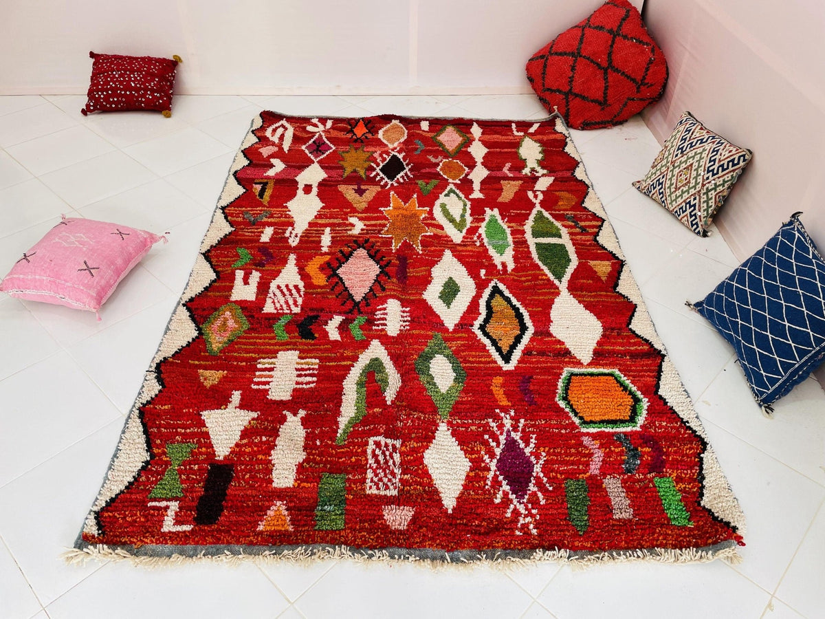 Lifestyle view of a red geometric vintage Moroccan rug featuring tribal designs.