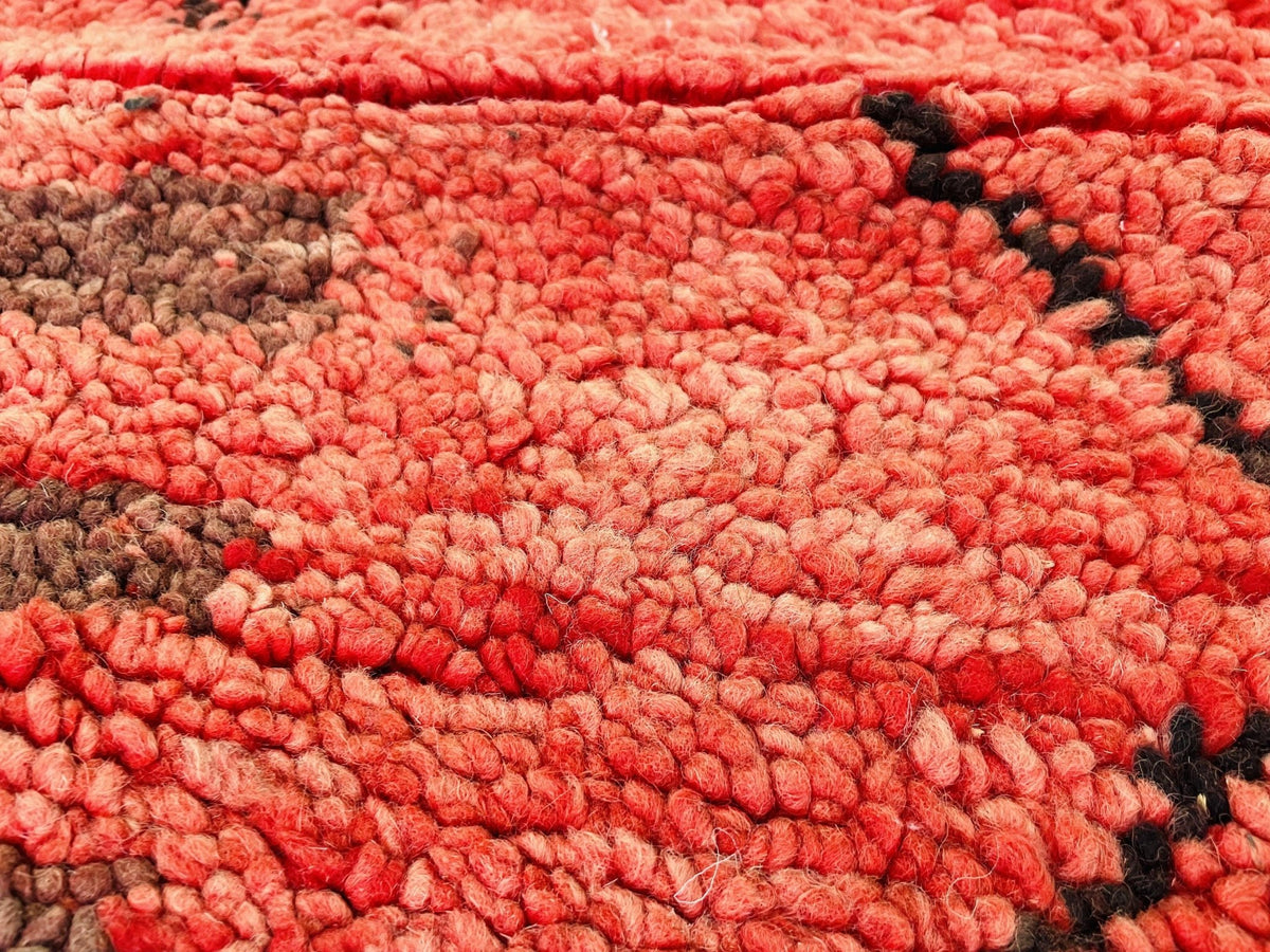 Detail view showcasing the tribal patterns and textured surface of the red vintage Boujaad Moroccan rug.