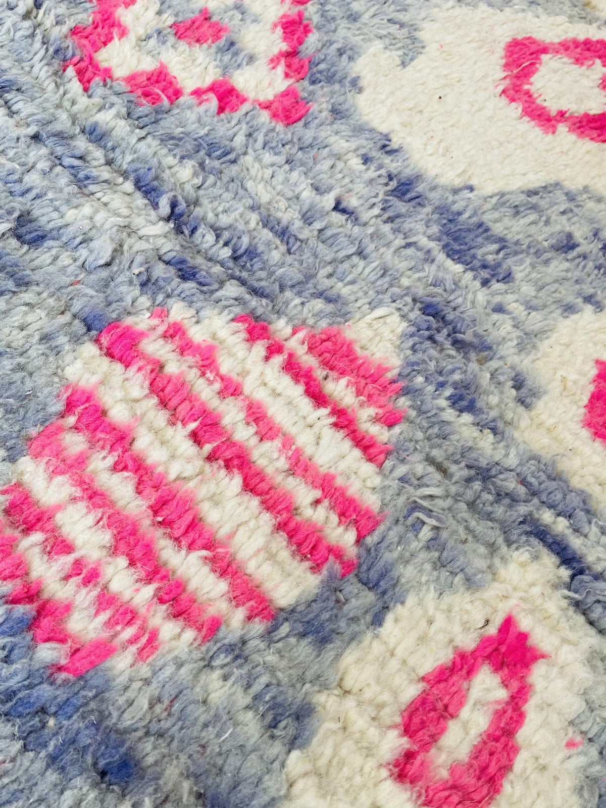 Close-up of a colorful vintage Boujaad Moroccan rug with striped patterns and a soft texture.