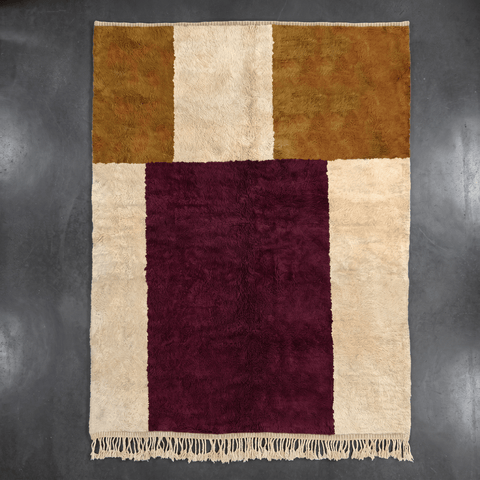 Top view of the beige and burgundy geometric pattern rug showcasing fringe edges.