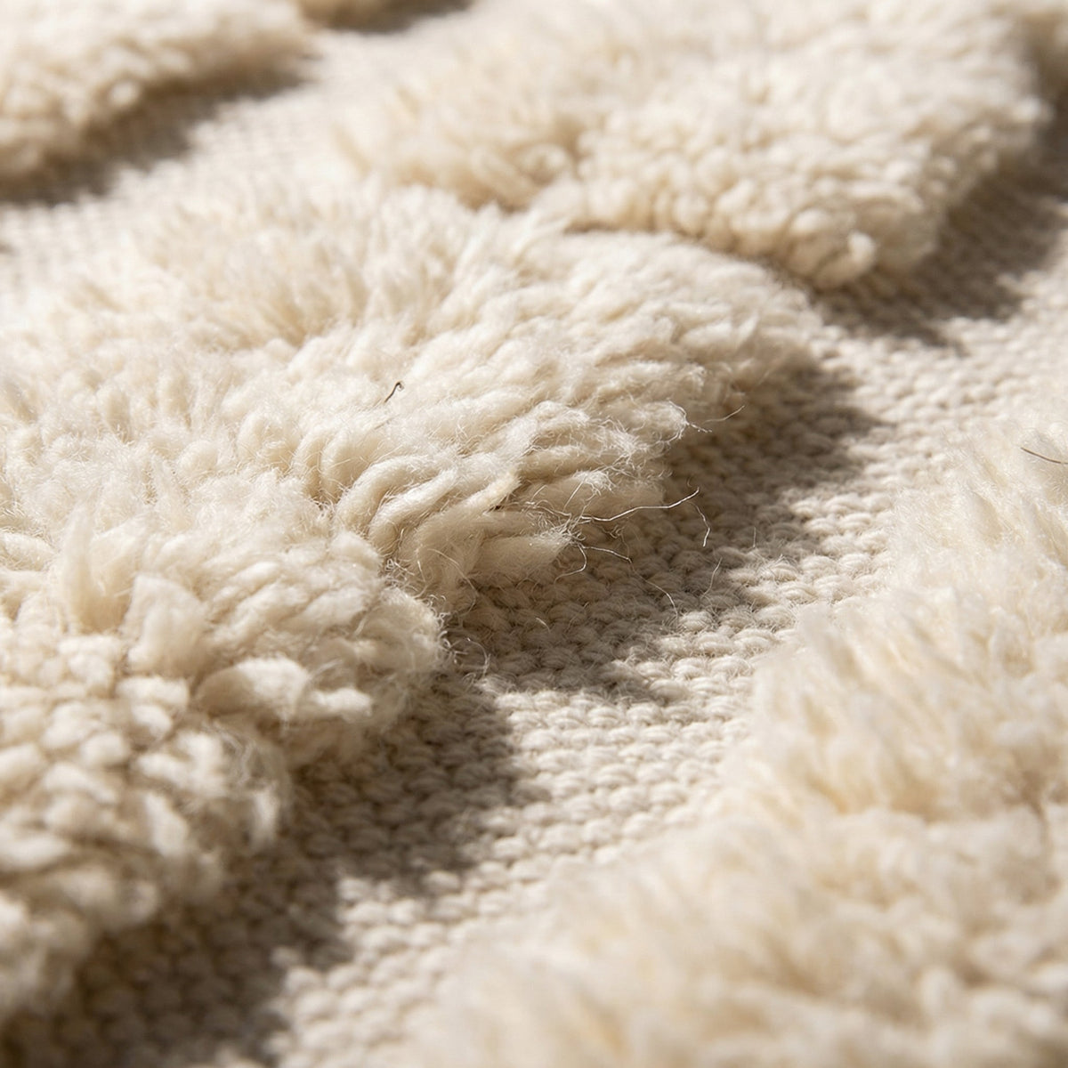 Front view of a beige Moroccan rug featuring a contemporary pattern against a solid backdrop.