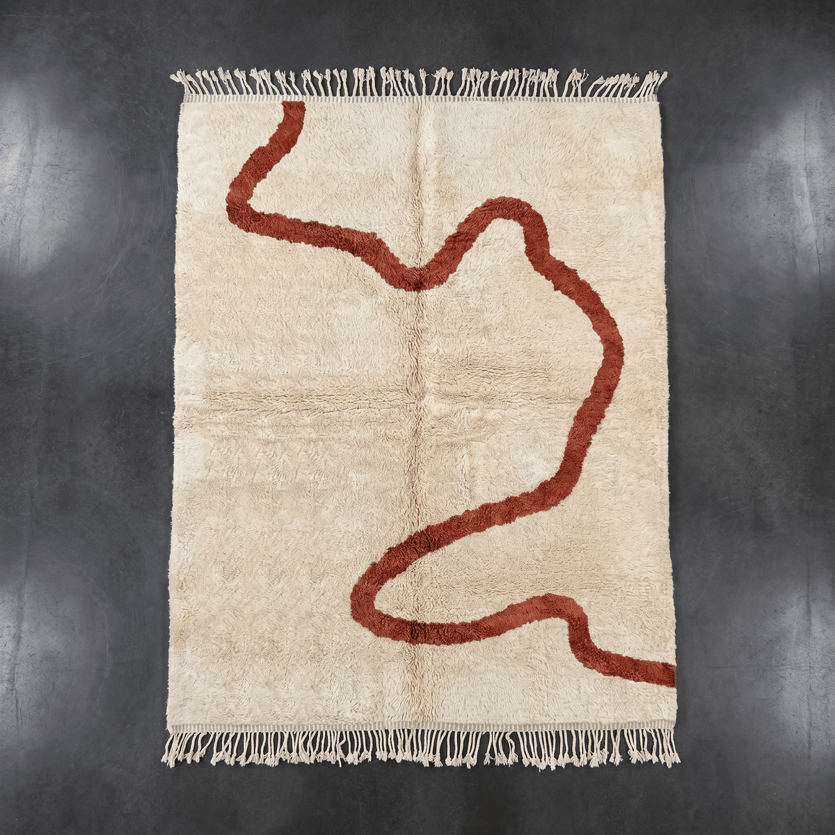 Front view of a beige Moroccan rug showcasing an abstract design with red highlights.