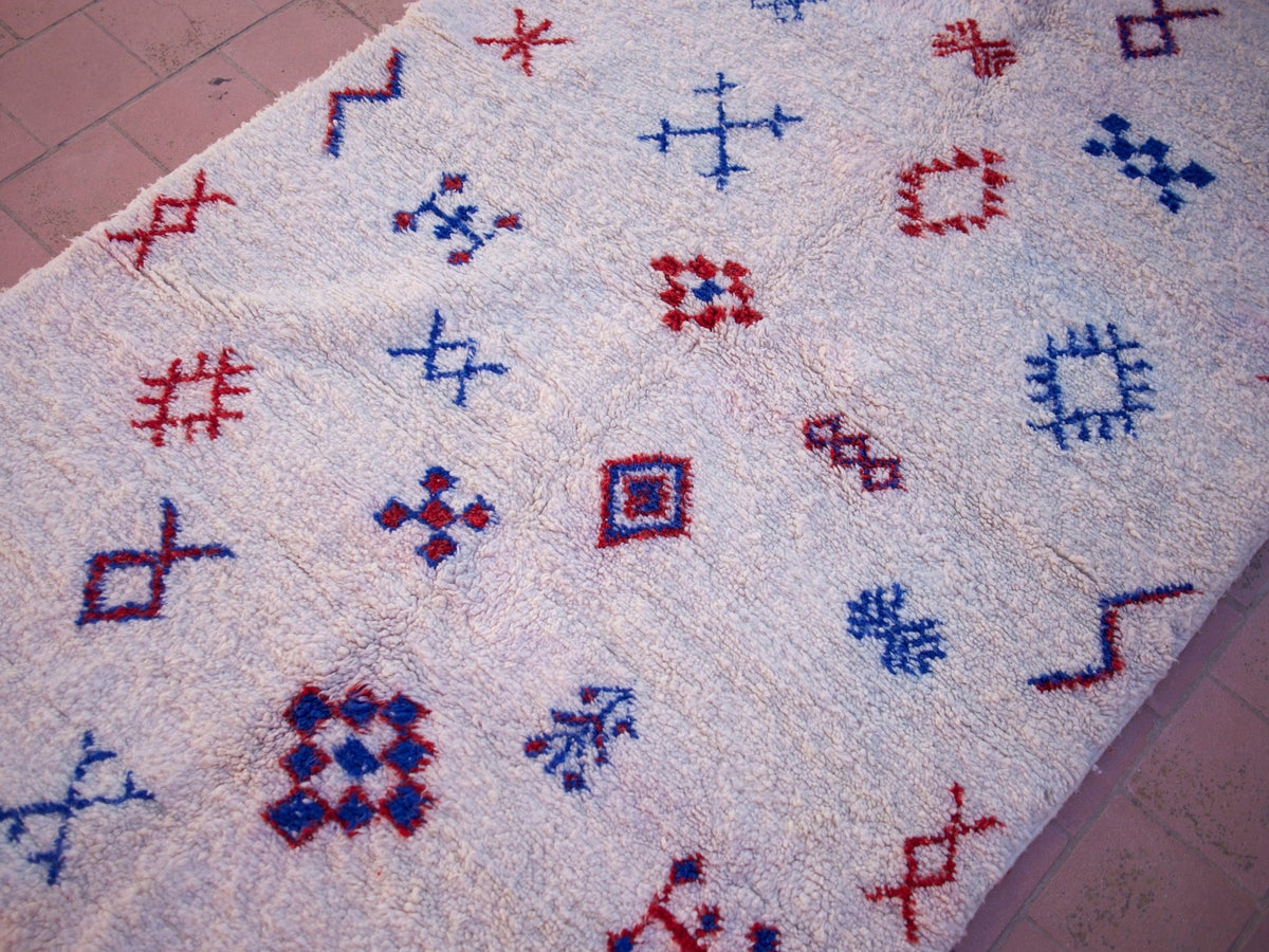 Close-up detail of various geometric designs on a multicolor Beni Ourain rug.