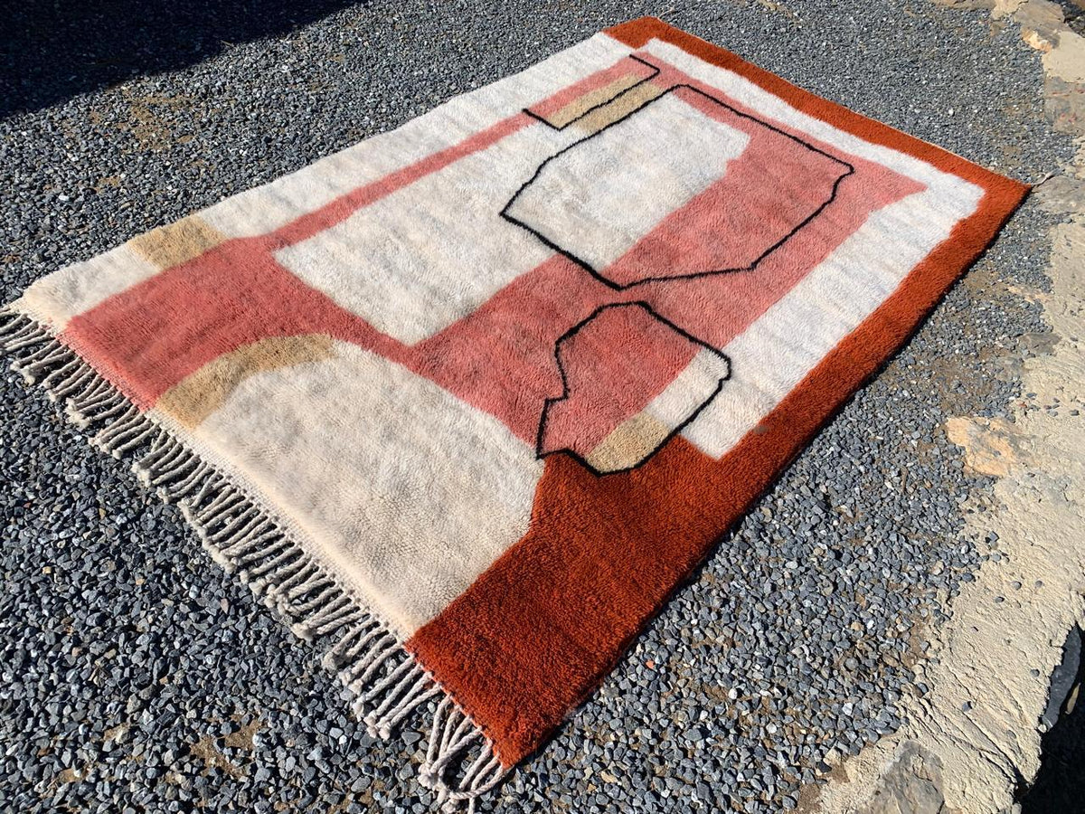 Side view showcasing the abstract patterns of the red and cream Moroccan rug.