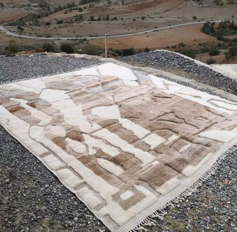 Side view showcasing the shaggy texture of the brown and cream abstract Moroccan rug.