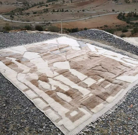 Side view showcasing the shaggy texture of the brown and cream abstract Moroccan rug.