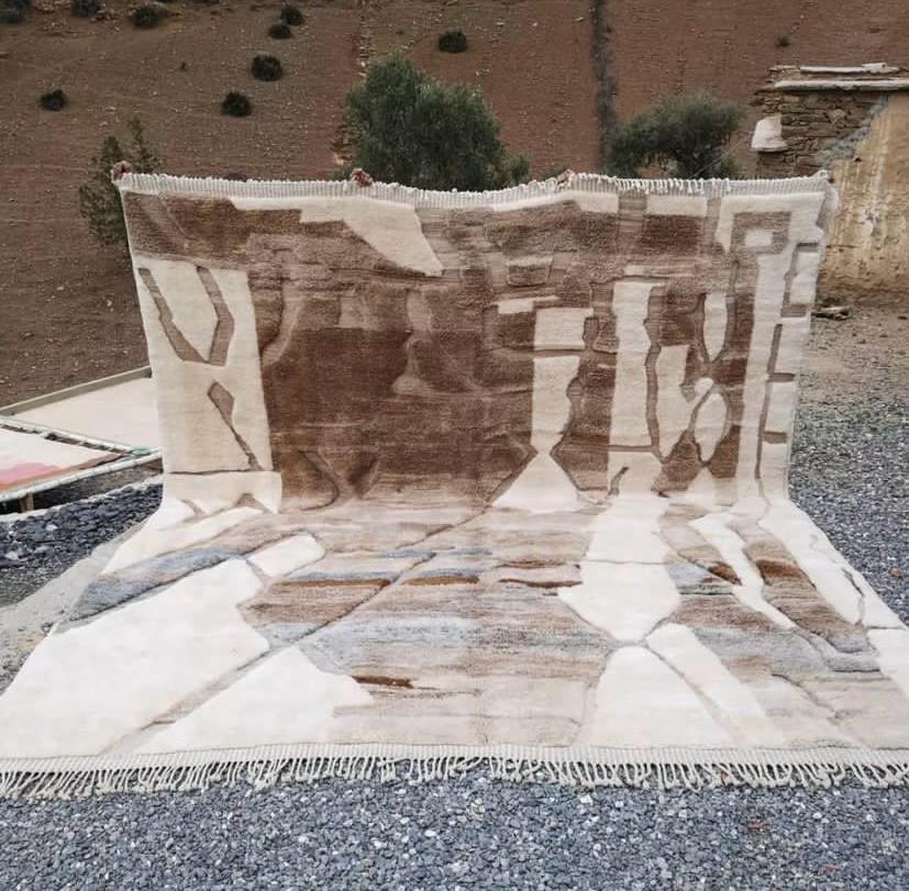 Lifestyle view of the brown and cream abstract Moroccan rug with shaggy texture.