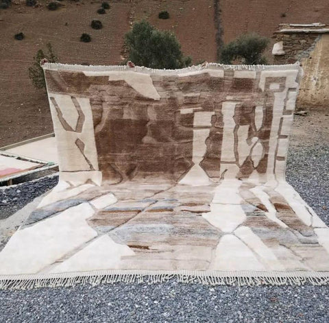 Lifestyle view of the brown and cream abstract Moroccan rug with shaggy texture.