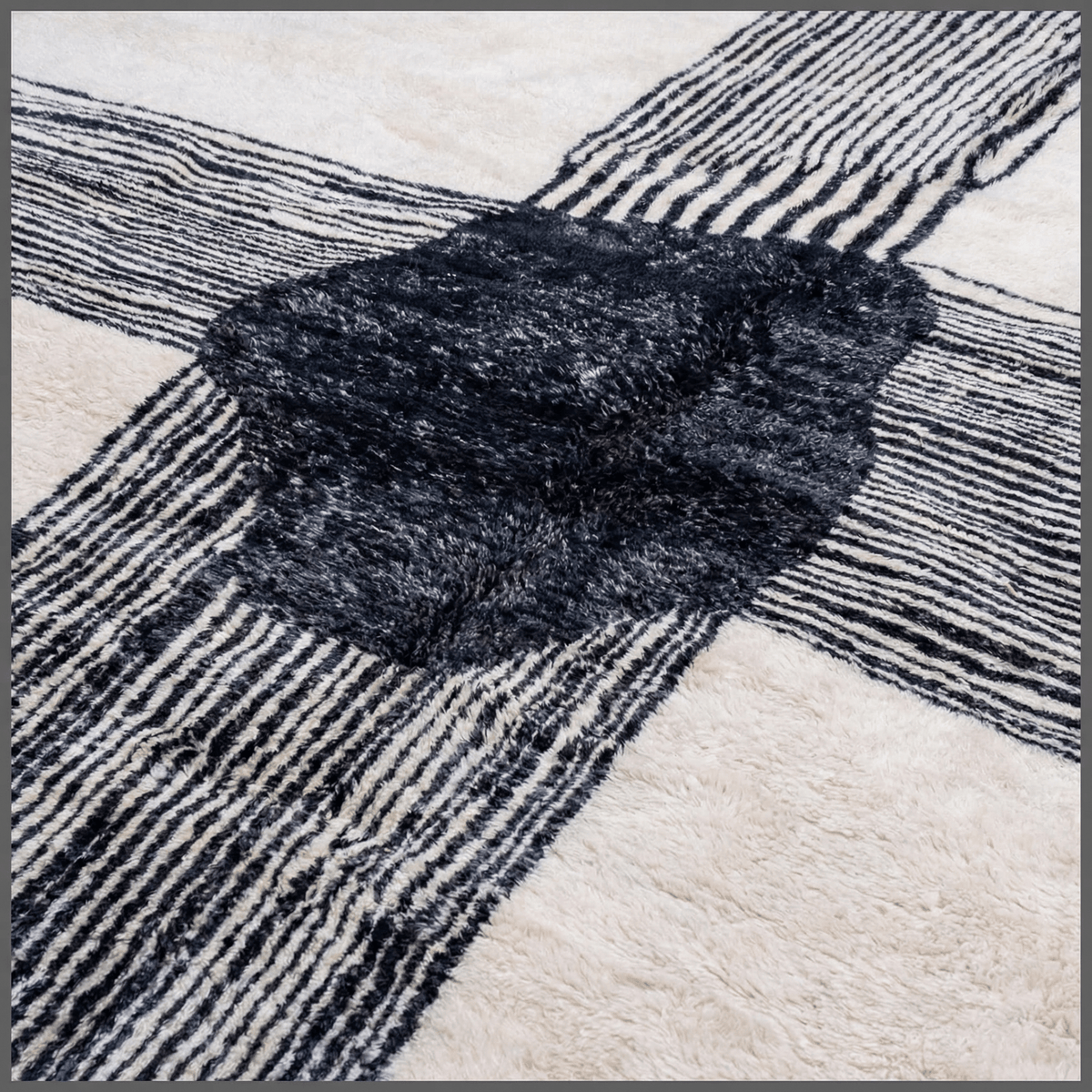 Close-up detail of a textured pattern on a black and white Moroccan rug.